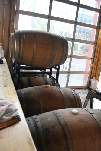 Some barrels where delicious beer (probably a stout) is picking up vanilla, bourbon, and oak notes.